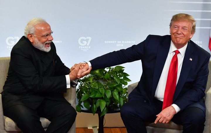Prime Minister Narendra Modi (L) and US President Donald Trump shake hands as they speak during a bilateral meeting in Biarritz, France on August 26, 2019, on the third day of the annual G7 Summit.