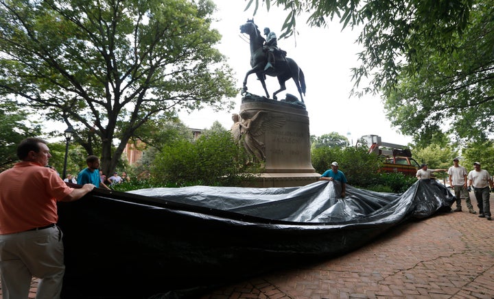 City workers preparing to drape a tarp over the statue of Confederate general Stonewall Jackson in Justice park in Charlottesville, Virginia, on Aug. 23, 2017. Judge Richard Moore later ordered for the tarp to be removed.