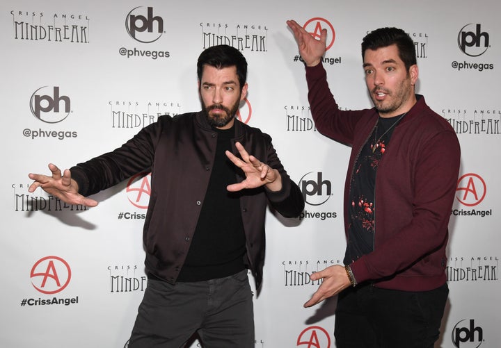 Property Brothers Drew Scott, left, and Jonathan Scott, right, strike a magician-esque pose at the grand opening of "Criss Angel: Mindfreak" on Jan. 19, 2019 in Las Vegas.