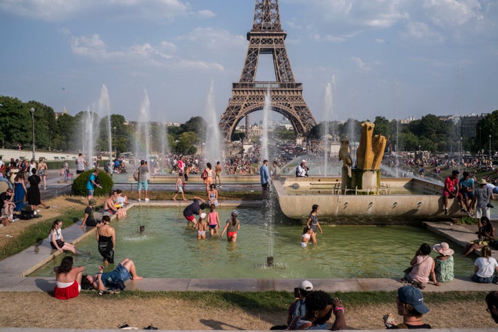 People cool off in the fountains of Paris' Trocadero gardens on July 25, 2019, when a new all-time high temperature of 108.7 degrees hit the French capital.