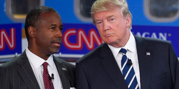 Republican presidential candidates Ben Carson, left, and Donald Trump talk before the start of the CNN...