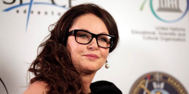 British singer Sarah Brightman poses for the photographers following a news conference, in central London,...