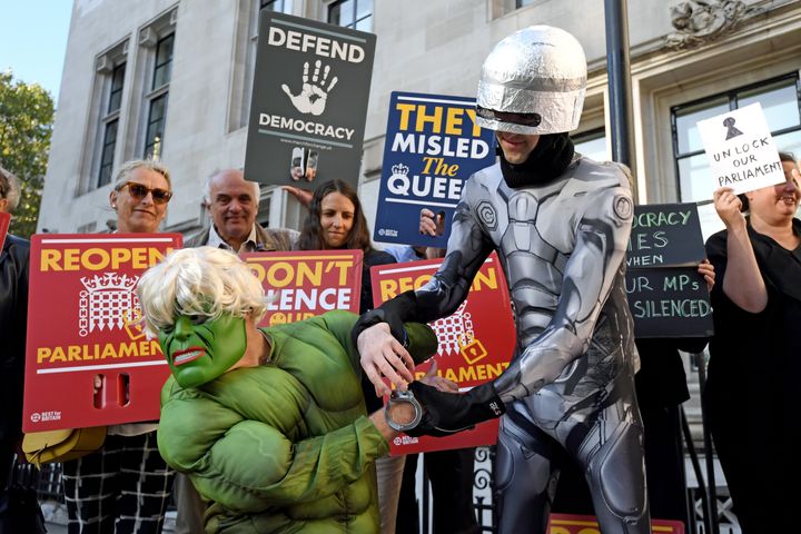 Protesters dressed as the Incredible Hulk and Robocop outside the Supreme Court 
