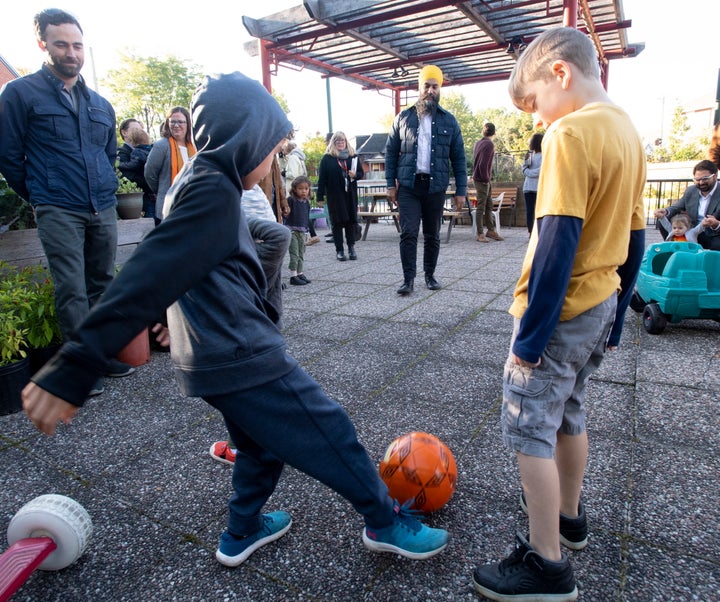 NDP Leader Jagmeet Singh plays soccer with children during a campaign stop in Ottawa on Tuesday. Singh says the NDP wants to help Canadians with no-cost, energy-efficiency upgrades.