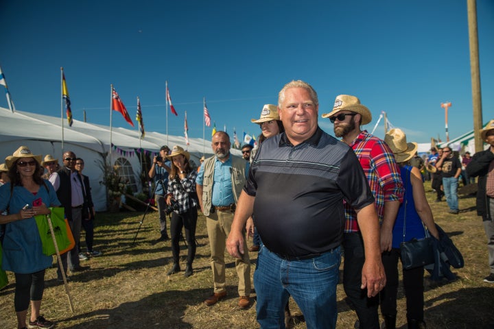 Ontario Premier Doug Ford welcomes visitors to the International Plowing Match in Verner, Ont. during the opening parade on Sept. 17, 2019.