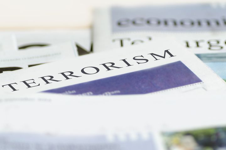 Daily news newspaper headline reading terrorism concept.