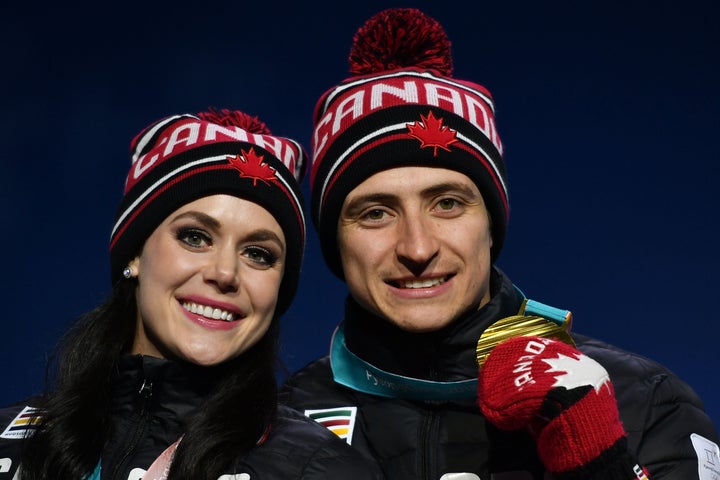 Canadian Olympic gold medallists Tessa Virtue and Scott Moir pose on the podium during a medal ceremony in Pyeongchang, South Korea, at the 2018 Winter Olympic Games on Feb. 20, 2018.