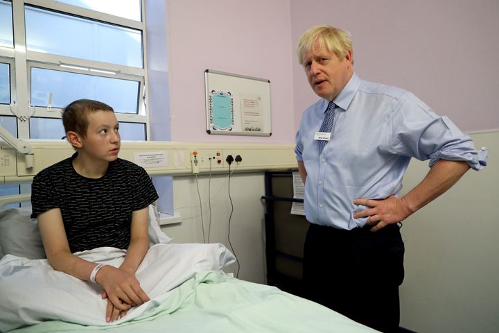 RETRANSMITTING WITH ADDITIONAL PATIENT INFORMATION Prime Minister Boris Johnson speaks with Conor, 14, a leukemia patient during a visit to Whipps Cross University Hospital in Leytonstone, east London.