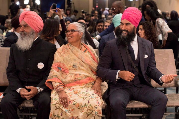 Jagmeet Singh (right) sits with his mother Harmeet Kaur (centre) and father Jagtaran Singh (left) attendees arrive hear the first ballot in the NDP leadership race in Toronto on Oct. 1, 2017.