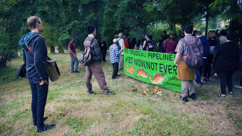 Members of a "resistance walk" against Trans Mountain pipeline expansion are shown in Burnaby, B.C. in July 2019.
