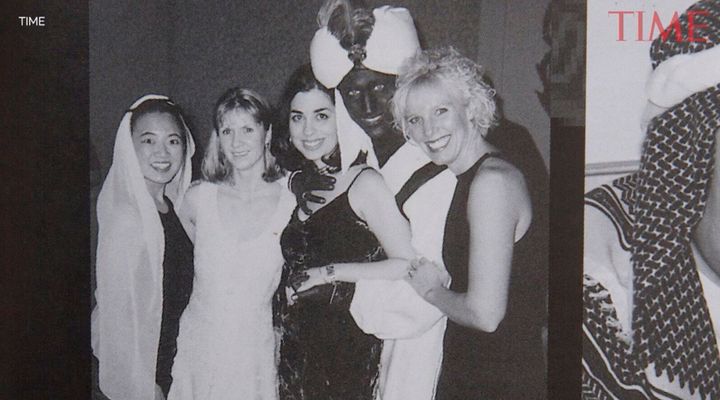 A yearbook photo shows Justin Trudeau, second from right, at a 2001 costume party with his hands and face blackened with makeup. It was published by Time Magazine Wednesday. 
