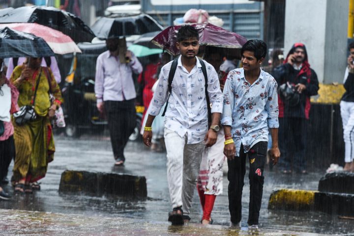 People deal with heavy rains in suburbs at Borivali on September 17, 2019 in Mumbai.