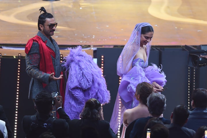 Ranveer Singh carries the back Deepika Padukone's dress during IIFA Awards.