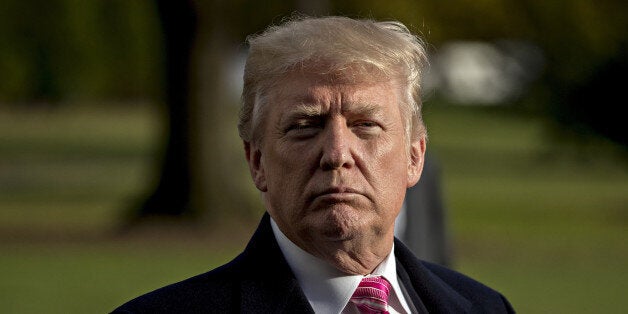 U.S. President Donald Trump listens to a question while speaking to members of the media before boarding Marine One on the South Lawn of the White House in Washington, D.C., U.S., on Tuesday, Nov. 21, 2017. Trump said AT&T Inc.'s $85 billion merger with Time Warner Inc. would be not good for the country, as he left the White House for his Thanksgiving holiday. Photographer: Andrew Harrer/Bloomberg via Getty Images