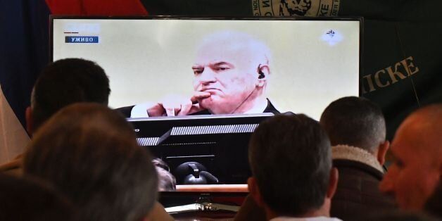 Former Bosnian Serbian commander Ratko Mladic appears on a TV screen wher people gather to watch a live broadcast from the International Criminal Tribunal for the former Yugoslavia (ICTY) on November 22, 2017 in Sokolac as UN judges began handing down their verdict in the trial of Mladic, accused of genocide and war crimes in the brutal Balkans conflicts over two decades ago. / AFP PHOTO / ELVIS BARUKCIC (Photo credit should read ELVIS BARUKCIC/AFP/Getty Images)