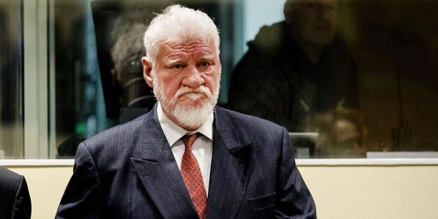 Croatian former general Slobodan Praljak stands prior to the start of his appeal judgement at the International Criminal Tribunal for the former Yugoslavia (ICTY) on November 29, 2017 at the Hague international court, in the court's final verdict for war crimes committed during the break-up of Yugoslavia. Praljak, 72, appeared to drink poison seconds after judges upheld his 20-year sentence. He shouted out angrily 'Praljak is not a criminal' then drank from a small brown bottle. The hearing was quickly suspended as his lawyer shouted out 'my client says he has taken poison.' / AFP PHOTO / ANP AND POOL / Robin van Lonkhuijsen (Photo credit should read ROBIN VAN LONKHUIJSEN/AFP/Getty Images)