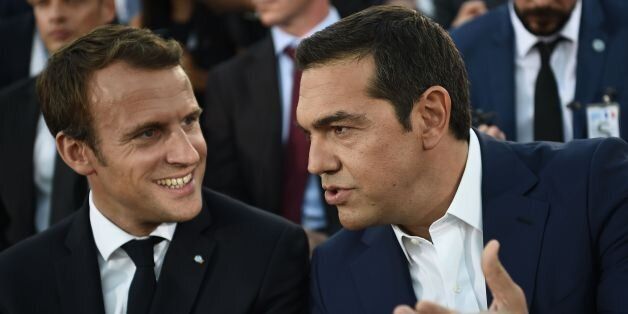 French President Emmanuel Macron (L) speaks with Greek Prime Minister Alexis Tsipras after arriving on the Pnyx hill in Athens on September 7, 2017, as part of his two-day official visit to Greece. / AFP PHOTO / ARIS MESSINIS (Photo credit should read ARIS MESSINIS/AFP/Getty Images)