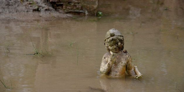 An ancient statue is partly submerged under water at an archaeological site, following flash floods which hit the area, at the village of Dion, Greece November 18, 2017. REUTERS/Alexandros Avramidis TPX IMAGES OF THE DAY