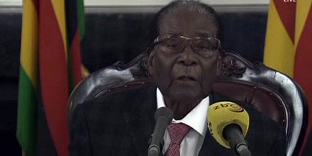 TOPSHOT - A video grab made on November 19, 2017 from footage of the broadcast of Zimbabwe Broadcasting corporation (ZBC) shows Zimbabwe's President Robert Mugabe delivering a speech in Harare, following a meeting with army chiefs who have seized power in Zimbabwe.Zimbabwean President Robert Mugabe, in a much-expected TV address, stressed he was still in power after his authoritarian 37-year reign was rocked by a military takeover. Many Zimbabweans expected Mugabe to resign after the army seized power last week. But Mugabe delivered his speech alongside the uniformed generals who were behind the military intervention. In his address, Mugabe made no reference to the clamour for him to resign. / AFP PHOTO / ZBC AND AFP PHOTO / STR / XGTY / RESTRICTED TO EDITORIAL USE - MANDATORY CREDIT 'AFP PHOTO / ZBC' - NO MARKETING NO ADVERTISING CAMPAIGNS - DISTRIBUTED AS A SERVICE TO CLIENTS (Photo credit should read STR/AFP/Getty Images)