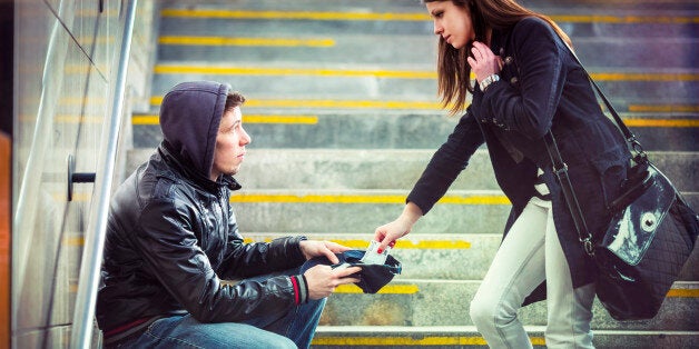 Young adult begging on the streets of Europe.