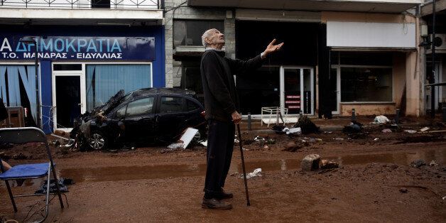 A local gestures as he stands next to a muddy street, following flash floods which hit areas west of Athens on November 15 killing at least 15 people, in Mandra, Greece, November 16, 2017. REUTERS/Alkis Konstantinidis