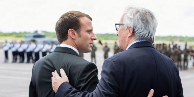 French President Emmanuel Macron (L) and European Commission President Jean-Claude Juncker embrace upon their arrival at the Cayenne Felix-Eboue airport at the start of a visit in Cayenne, French Guiana, on October 26, 2017.Macron arrived on October 26 for a 48-hour visit to French Guiana, six months after a social movement and protests that paralyzed the French department in South America. / AFP PHOTO / POOL / RONAN LIETAR (Photo credit should read RONAN LIETAR/AFP/Getty Images)