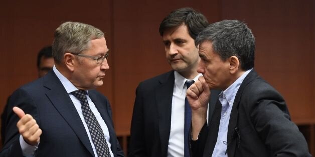 (L-R) Managing Director of the European Stability Mechanism Klaus Regling, Greek Alternate Minister of Finance George Chouliarakis and Greece's Finance Minister Euclid Tsakalotos speak during an Eurogroup finance ministers' meeting at the European Council in Brussels, January 14, 2016. / AFP / EMMANUEL DUNAND (Photo credit should read EMMANUEL DUNAND/AFP/Getty Images)