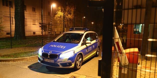 A police car leaves the grounds of a reception centre for asylum seekers in Bamberg, southern Germany, on early November 15, 2017.A man was killed and 14 residents of the home were injured as a fire broke out. The cause of the fire is yet unclear. / AFP PHOTO / dpa / Daniel Karmann / Germany OUT (Photo credit should read DANIEL KARMANN/AFP/Getty Images)