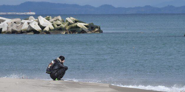 A man visits the seashore in Sendai's Arahama area, Miyagi prefecture on March 11, 2017 to pray for victims of the 2011 quake-tsunami disaster.Japan is marking on March 11 the sixth anniversary of the magnitude 9.0 quake which struck under the Pacific Ocean and the ensuing tsunami which left about 18,500 people dead or missing. / AFP PHOTO / KAZUHIRO NOGI (Photo credit should read KAZUHIRO NOGI/AFP/Getty Images)