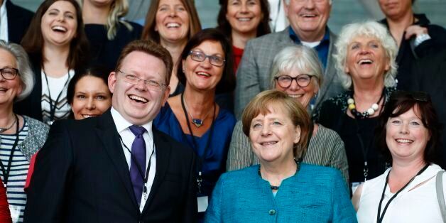 German Chancellor Angela Merkel (C-R) poses with Altena's mayor Andreas Hollstein (C-L) and other winners of the national integration award at the Chancellery in Berlin on May 17, 2017. / AFP PHOTO / Odd ANDERSEN (Photo credit should read ODD ANDERSEN/AFP/Getty Images)