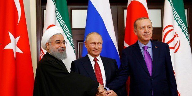 SOCHI, RUSSIA - NOVEMBER 22: Turkish President Recep Tayyip Erdogan (R), Russian President Vladimir Putin (C) and Iranian President Hassan Rouhani (L) pose for a photo ahead of the trilateral summit to discuss progress on Syria, between the Presidents of Turkey, Russia and Iran on November 22, 2017 in Sochi, Russia . (Photo by Sefa Karacan/Anadolu Agency/Getty Images)
