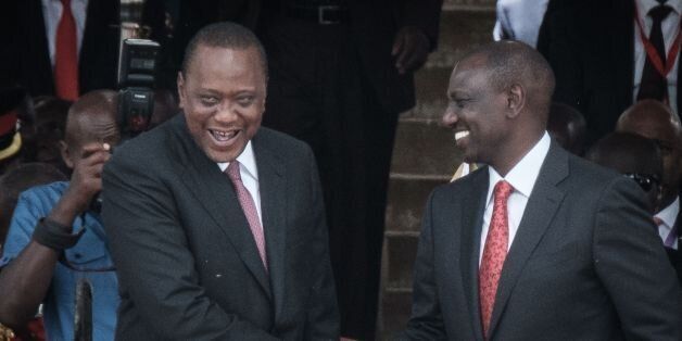 Kenya's President Uhuru Kenyatta (L) and Vice-President William Ruto shake hands after taking oath of office during the inauguration ceremony at Kasarani Stadium in Nairobi, Kenya, on November 28, 2017.President Uhuru Kenyatta vowed to be the leader of all Kenyans and work to unite the country after a bruising and drawn out election process that ended with his swearing-in. / AFP PHOTO / YASUYOSHI CHIBA (Photo credit should read YASUYOSHI CHIBA/AFP/Getty Images)