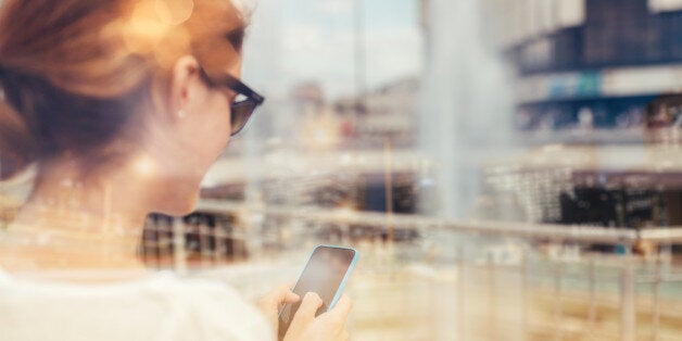 Woman text messaging on mobile phone