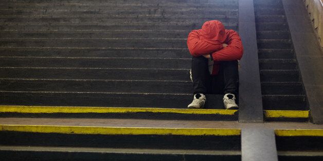 young homeless man sleeping on the street, poverty, city