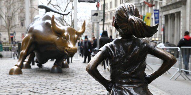 NEW YORK, USA - MARCH 29: The 'Fearless Girl' statue, a four-foot statue of a young girl, defiantly looks up the iconic Wall Street 'Charging Bull' sculpture in New York City, United States on March 29, 2017. 'Fearless Girl' statue was installed in front of the bronze 'Charging Bull' for International Women's Day earlier this month to draw attention to the gender pay gap and lack of gender diversity on corporate boards in the financial sector. The statue will remain at her post until February 2018. (Photo by Volkan Furuncu/Anadolu Agency/Getty Images)