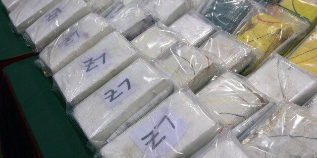 Packages of cocaine are displayed during a news conference held by the Hong Kong Customs and Excise Department in Hong Kong August 14, 2013. Customs officers have seized a total of 60 kilograms (132 pounds) of cocaine, estimated to be worth HK$58 million ($7.5 million), from two passengers at the airport. Forty-eight kilos were found in the suitcases of a man from Brazil, while the rest was found in the luggage of a woman arriving on the same flight, government radio reported on Wednesday. REUTERS/Tyrone Siu (CHINA - Tags: SPORT SOCCER CRIME LAW DRUGS SOCIETY)