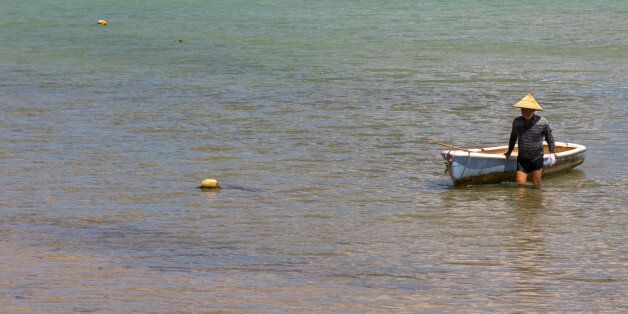 ISHIGAKI, JAPAN - AUGUST 28: Japanese fisherman in tropical lagoon with clear blue water in Kabira bay, Yaeyama Islands, Ishigaki, Japan on August 28, 2017 in Ishigaki, Japan. (Photo by Eric Lafforgue/Art In All Of Us/Corbis via Getty Images)