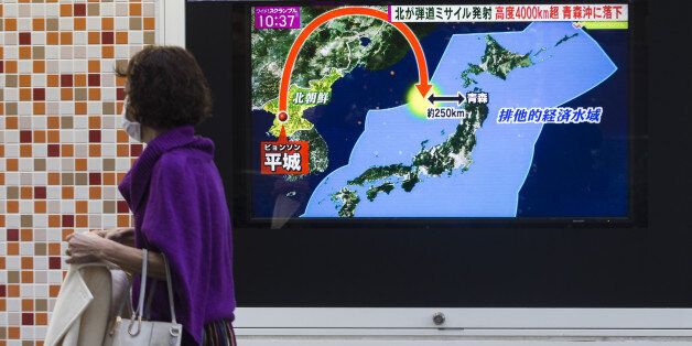 A pedestrian walks past a screen broadcasting a map of Japan and the Korean Peninsula during a news program reporting on North Korea's missile launch in Tokyo, Japan, on Wednesday, Nov. 29, 2017. North Korea shattered a two-month period of relative quiet by test-firing a missile that analysts say may put the U.S. east coast in range. Photographer: Keith Bedford/Bloomberg via Getty Images