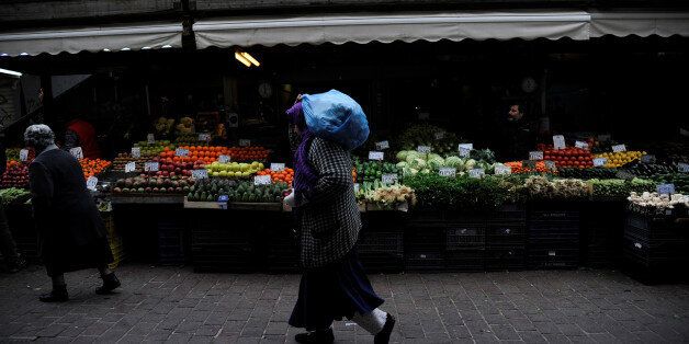 A woman walks past a vegetable market in central Athens, Greece February 11, 2017. REUTERS/Michalis Karagiannis