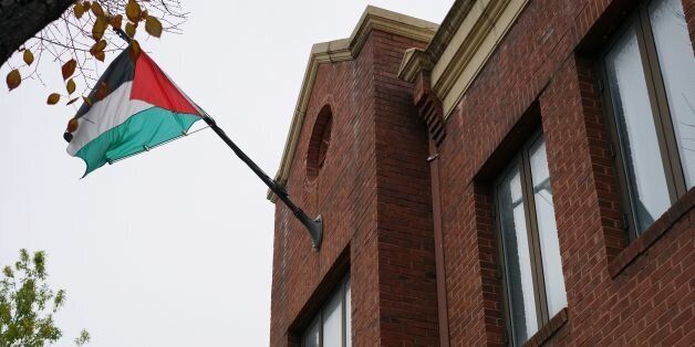 The flag of the Palestine Liberation Organisation is seen above its offices in Washington, DC on November 18, 2017.The Palestinians will freeze their ties with the US if it follows through on a threat to close the Palestine Liberation Organisation's office in Washington, a senior PLO official warned Saturday. The surprise American move and Palestinian backlash came as US President Donald Trump seeks bargaining chips in his bid to broker an elusive Israeli-Palestinian peace deal.Trump has a 90-day window to avert the closure if he deems progress has been made. / AFP PHOTO / MANDEL NGAN (Photo credit should read MANDEL NGAN/AFP/Getty Images)