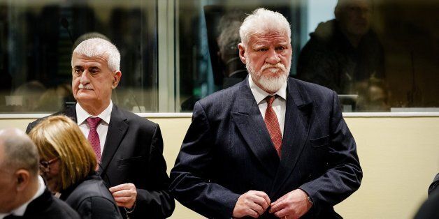 Former Bosnian Croat Defense Minister Bruno Stojic and former Croatian general Slobodan Praljak (R) are pictured prior to the judgement in their appeals case, along with four other former Bosnian Croat political and military leaders, on November 29, 2017 at the Hague international court, in the court's final verdict for war crimes committed during the break-up of Yugoslavia. / AFP PHOTO / ANP AND POOL / Robin van Lonkhuijsen (Photo credit should read ROBIN VAN LONKHUIJSEN/AFP/Getty Images)