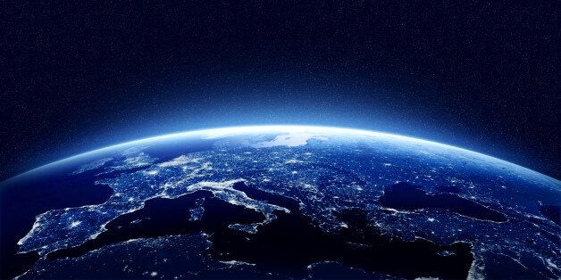 Earth at night as seen from space with blue, glowing atmosphere and space at the top. Perfect for illustrations. Elements of this image furnished by NASA
