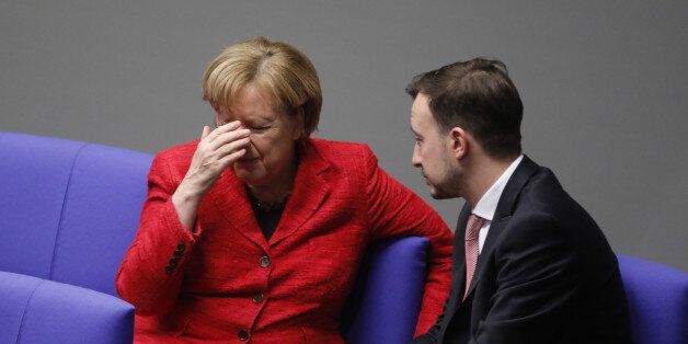 BERLIN, GERMANY - NOVEMBER 21: German Chancellor and leader of the German Christian Democrats (CDU) Angela Merkel speaks with Paul Ziemiak, chairman of the young associacion of the CDU party during the first session of the Bundestag, the German parliament, since the collapse of government coalition talks on November 21, 2017 in Berlin, Germany. Preliminary coalition talks, after over three weeks of arduous meetings, fell apart Sunday night, leaving Merkel confronted with two uncomfortable possibilities: attempt to run a minority government together with the German Greens Party or submit to new elections. Both would be a first at the federal level in post-World War II German history. (Photo by Michele Tantussi/Getty Images)