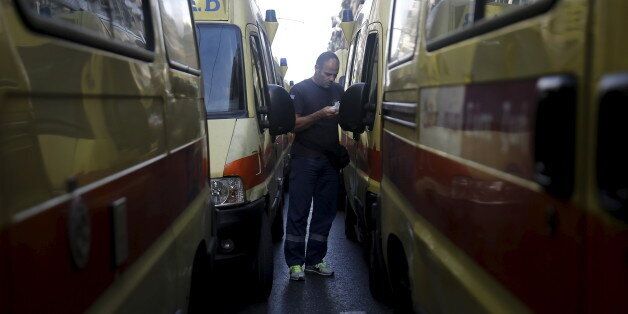 A rescuer of the Greek National Centre of First Aid walks among ambulances during a protest outside the Health Ministry against government policies affecting their sector in Athens, Greece, November 24, 2015. REUTERS/Alkis Konstantinidis