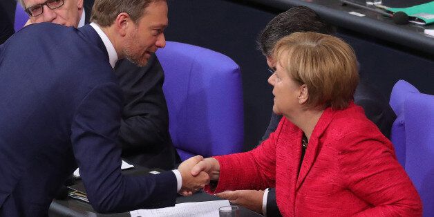Christian Lindner, leader of the Free Democratic Party (FDP), left, shakes hands with Angela Merkel, Germany's chancellor, inside the lower-house of the German Parliament in Berlin, Germany, on Tuesday, Nov. 21, 2017. Merkel said shes ready to face voters again to break the countrys political stalemate, betting they wont blame her for failed talks on forming a coalition. Photographer: Krisztian Bocsi/Bloomberg via Getty Images