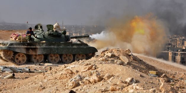 A Syrian government forces' tank fires rounds in the eastern city of Deir Ezzor during an operation against Islamic State (IS) group jihadists on November 2, 2017.Syria's army and allied fighters have captured the city of Deir Ezzor from the Islamic State group in a Russian-backed operation, a monitor said on November 2, 2017. / AFP PHOTO / STRINGER (Photo credit should read STRINGER/AFP/Getty Images)
