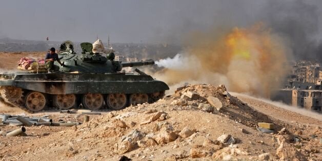 A Syrian government forces' tank fires rounds in the eastern city of Deir Ezzor during an operation against Islamic State (IS) group jihadists on November 2, 2017.Syria's army and allied fighters have captured the city of Deir Ezzor from the Islamic State group in a Russian-backed operation, a monitor said on November 2, 2017. / AFP PHOTO / STRINGER (Photo credit should read STRINGER/AFP/Getty Images)