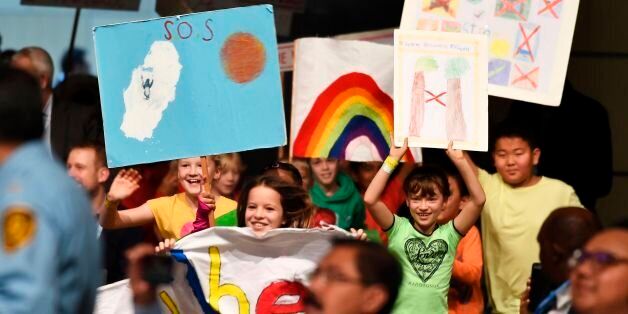 A group of kids perform and display drawings about climate change at the opening session of the COP23 United Nations Climate Change Conference on November 6, 2017 in Bonn, Germany.The 23rd UN climate conference (COP23) opens, the first such gathering since President Donald Trump announced he would extricate the US from the 2015 Paris Agreement aimed at curbing global warming. / AFP PHOTO / PATRIK STOLLARZ (Photo credit should read PATRIK STOLLARZ/AFP/Getty Images)