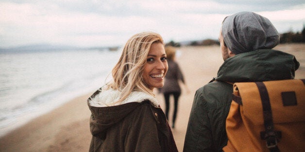 Group of friends enjoying in a walk by the sea