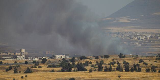 A picture taken from the Israeli-occupied Golan Heights shows smoke billowing from the Syrian side of the border on June 24, 2017.An Israeli aircraft carried out a strike on Syria after 10 projectiles hit the occupied Golan Heights, an army spokesman said. The Israeli Air Force also targeted two tanks of the 'Syrian regime' in the northern part of the Golan, the spokesman said, adding the projectiles did not cause any casualties. / AFP PHOTO / JALAA MAREY (Photo credit should read JALAA MAREY/AFP/Getty Images)